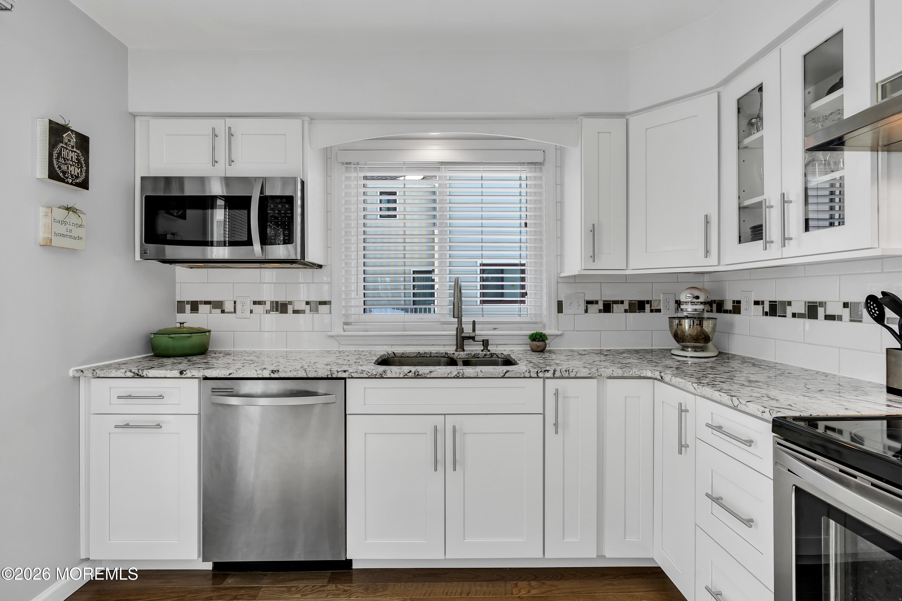 580 Patten Avenue, Unit 14 Long Branch, NJ 07740 - Photo 5 of 29 a kitchen with stainless steel appliances granite countertop a sink and cabinets