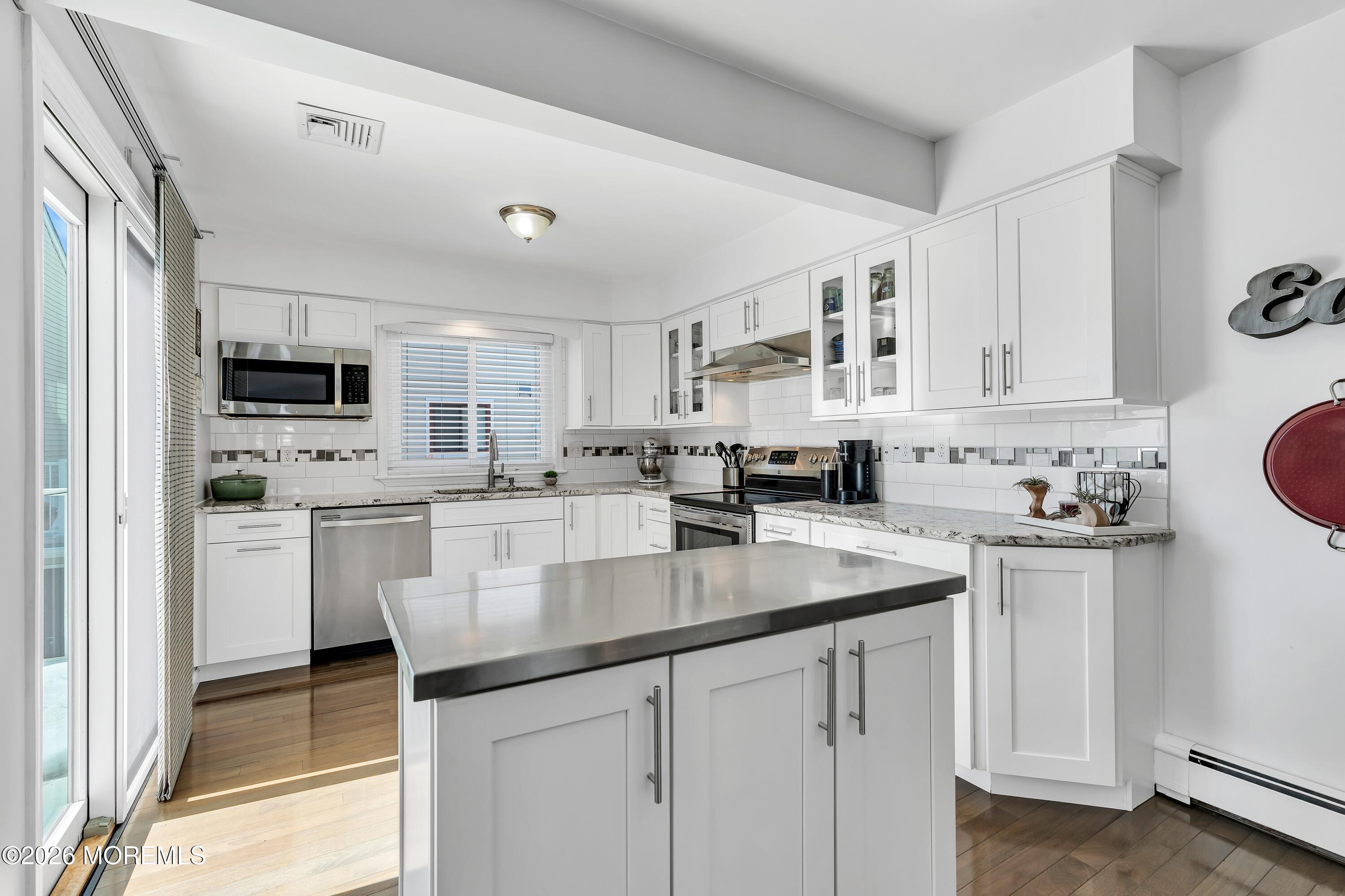 580 Patten Avenue, Unit 14 Long Branch, NJ 07740 - Photo 6 of 29 a kitchen with white cabinets and sink