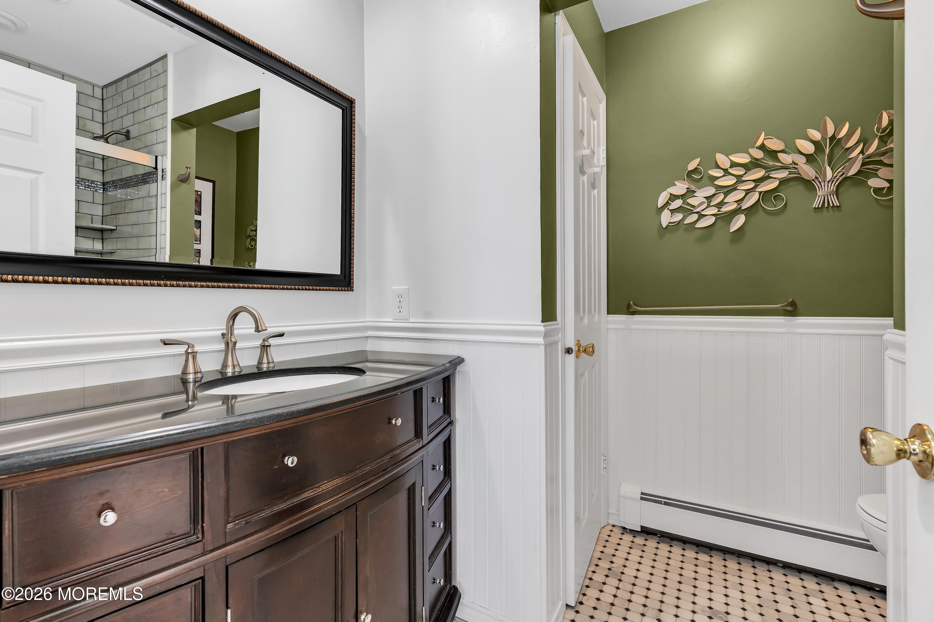 580 Patten Avenue, Unit 14 Long Branch, NJ 07740 - Photo 10 of 29 a bathroom with a sink a mirror and a toilet