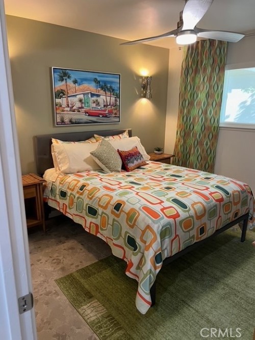 72724 Eagle Road, Unit 1 Palm Desert, CA 92260 - Photo 14 of 22 a bedroom with a bed and a painting on the wall
