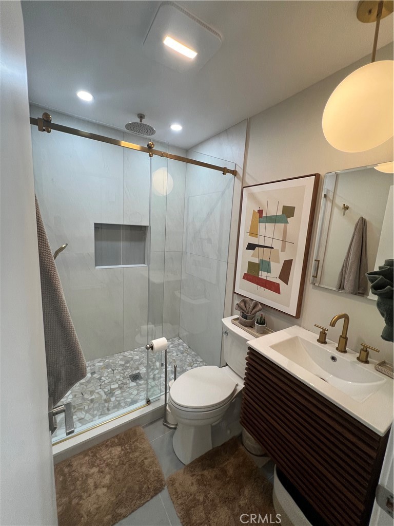 72724 Eagle Road, Unit 1 Palm Desert, CA 92260 - Photo 17 of 22 a bathroom with a sink toilet and shower