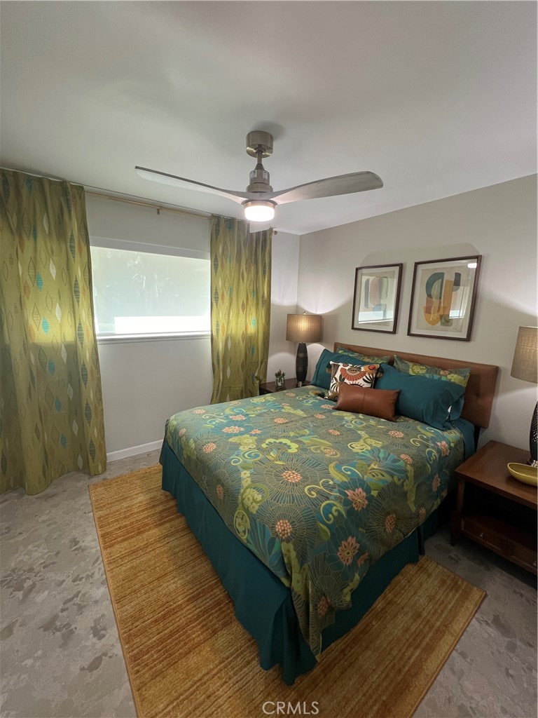 72724 Eagle Road, Unit 1 Palm Desert, CA 92260 - Photo 18 of 22 a bedroom with a large bed and a chandelier