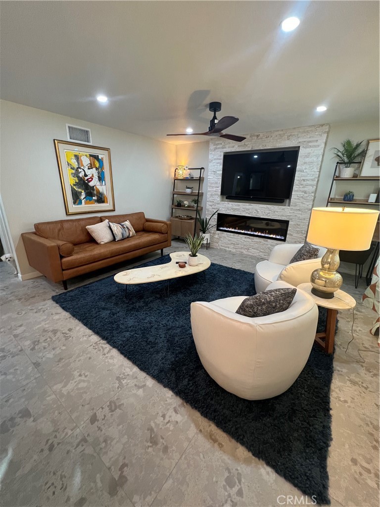 72724 Eagle Road, Unit 1 Palm Desert, CA 92260 - Photo 9 of 22 a living room with furniture and a flat screen tv