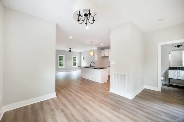 a view of kitchen and hall with wooden floor