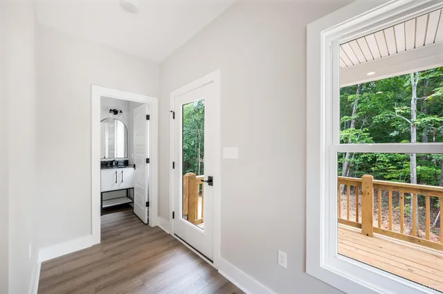 a view of an entryway with wooden floor and windows