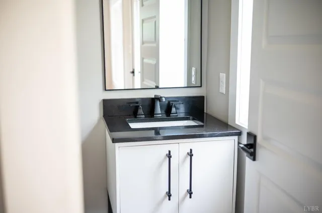 a view of kitchen with granite countertop window