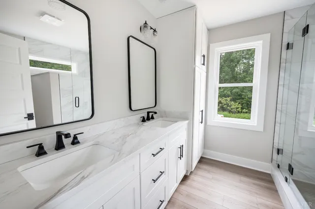 a bathroom with double vanity sinks and a mirror
