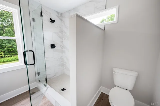 a bathroom with a toilet and a shower