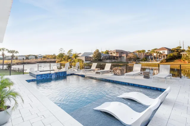 a view of a rooftop deck with patio and lake view