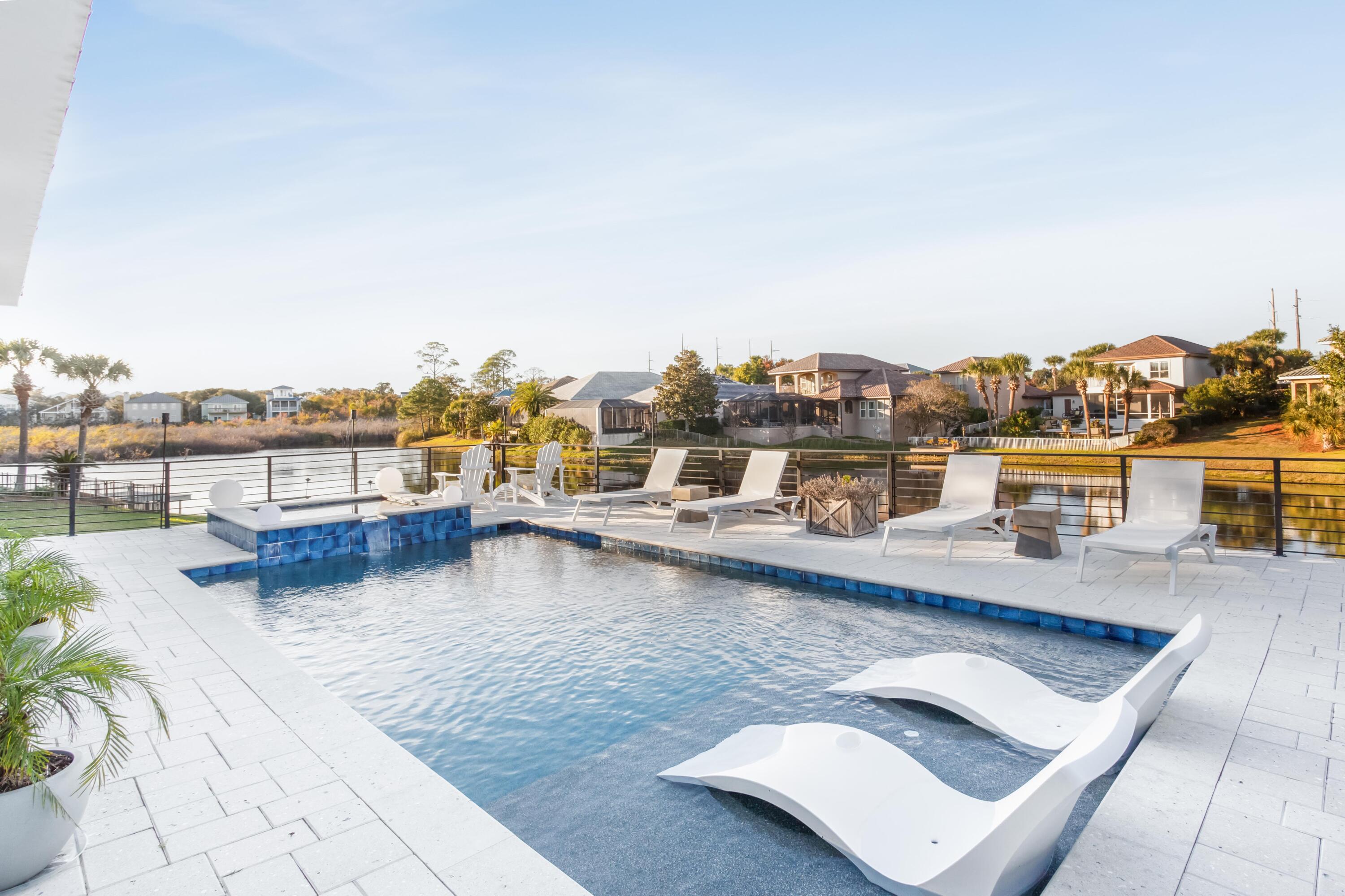 a view of a rooftop deck with patio and lake view