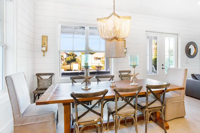 a kitchen with a table chairs stove and refrigerator
