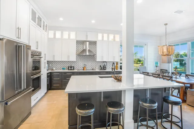 a kitchen with a stove a sink and a refrigerator