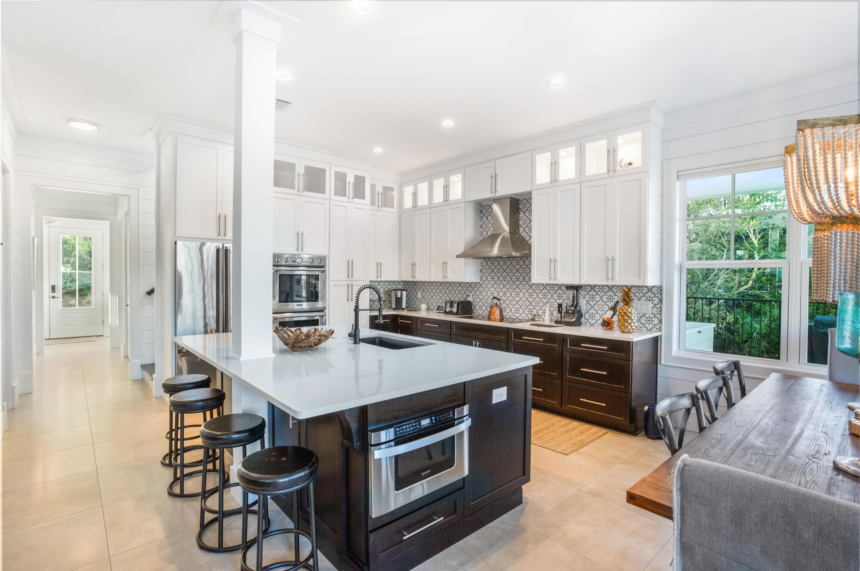 4627 Sunset Pointe Destin, FL 32541 - Photo 16 of 64 a kitchen with a stove a sink and a refrigerator