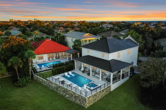 a aerial view of a house with swimming pool and a yard
