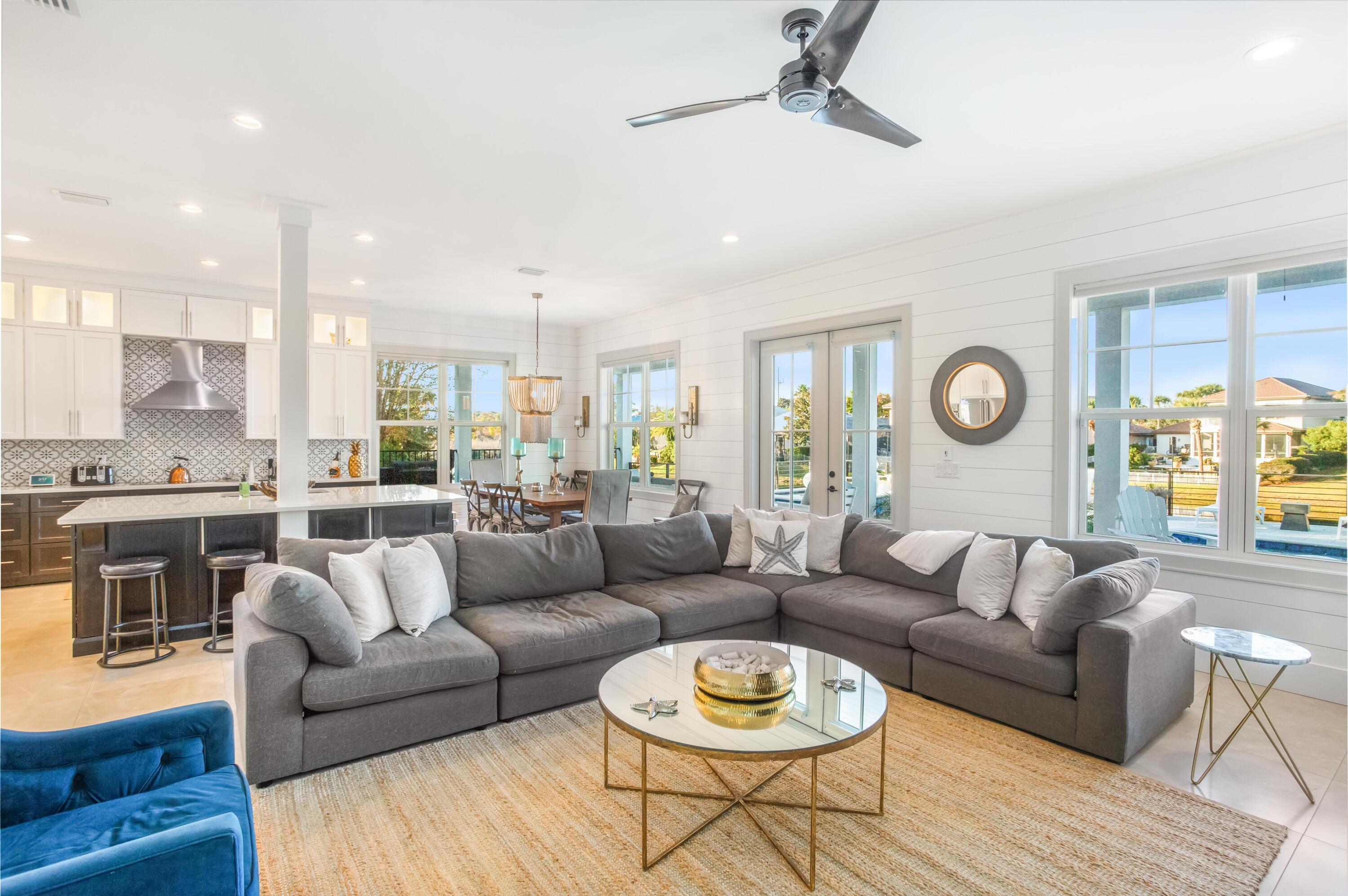 4627 Sunset Pointe Destin, FL 32541 - Photo 23 of 64 a living room with furniture kitchen view and a large window