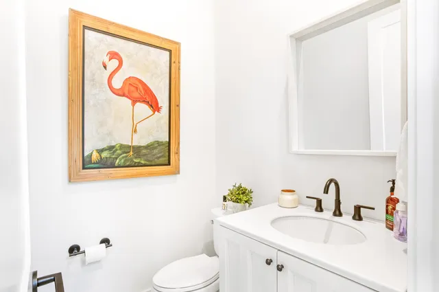 a bathroom with a sink toilet and mirror
