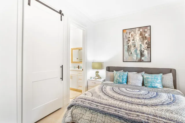 a bedroom with a bed and a table