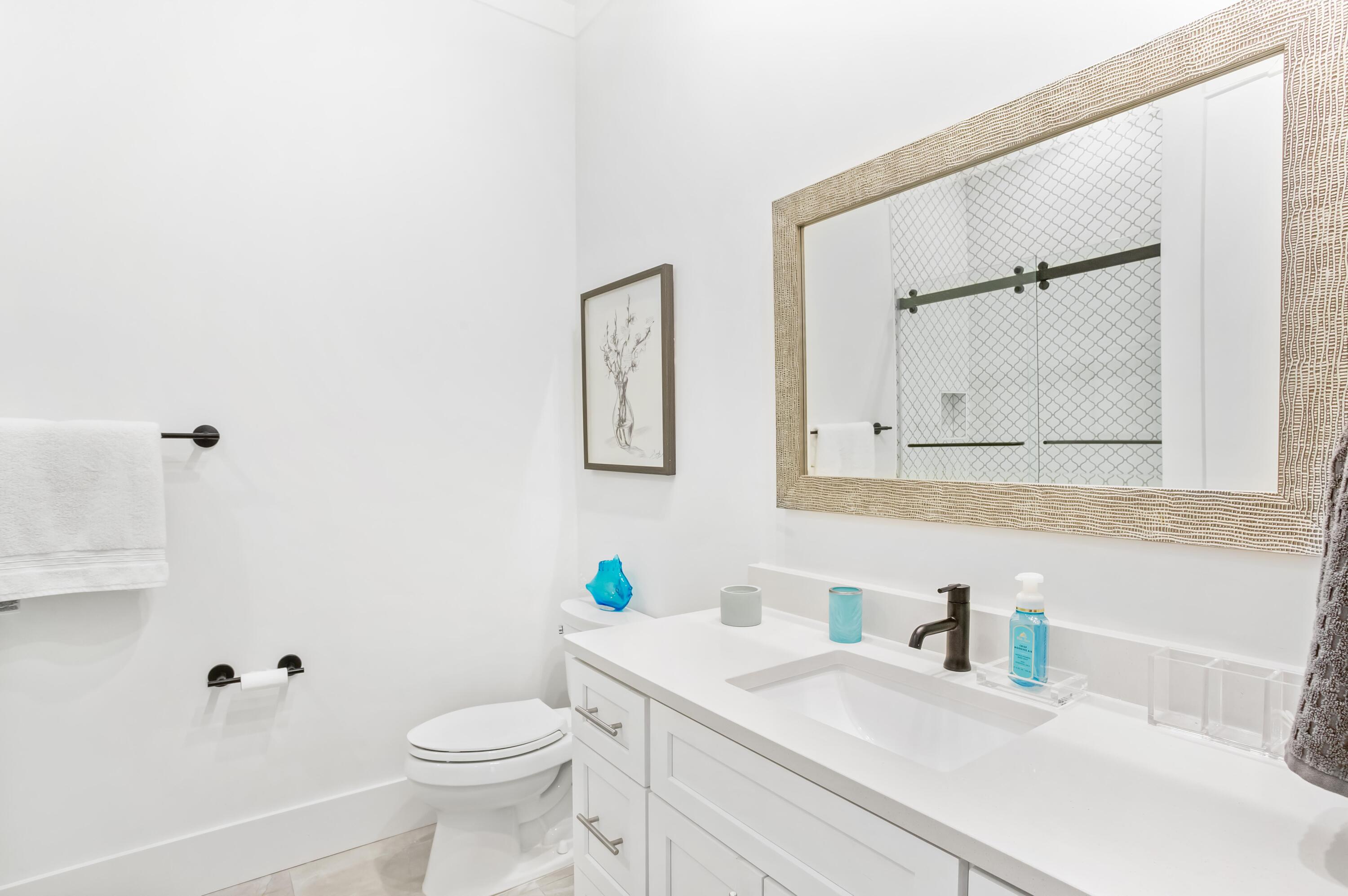 4627 Sunset Pointe Destin, FL 32541 - Photo 29 of 64 a bathroom with a sink toilet and mirror