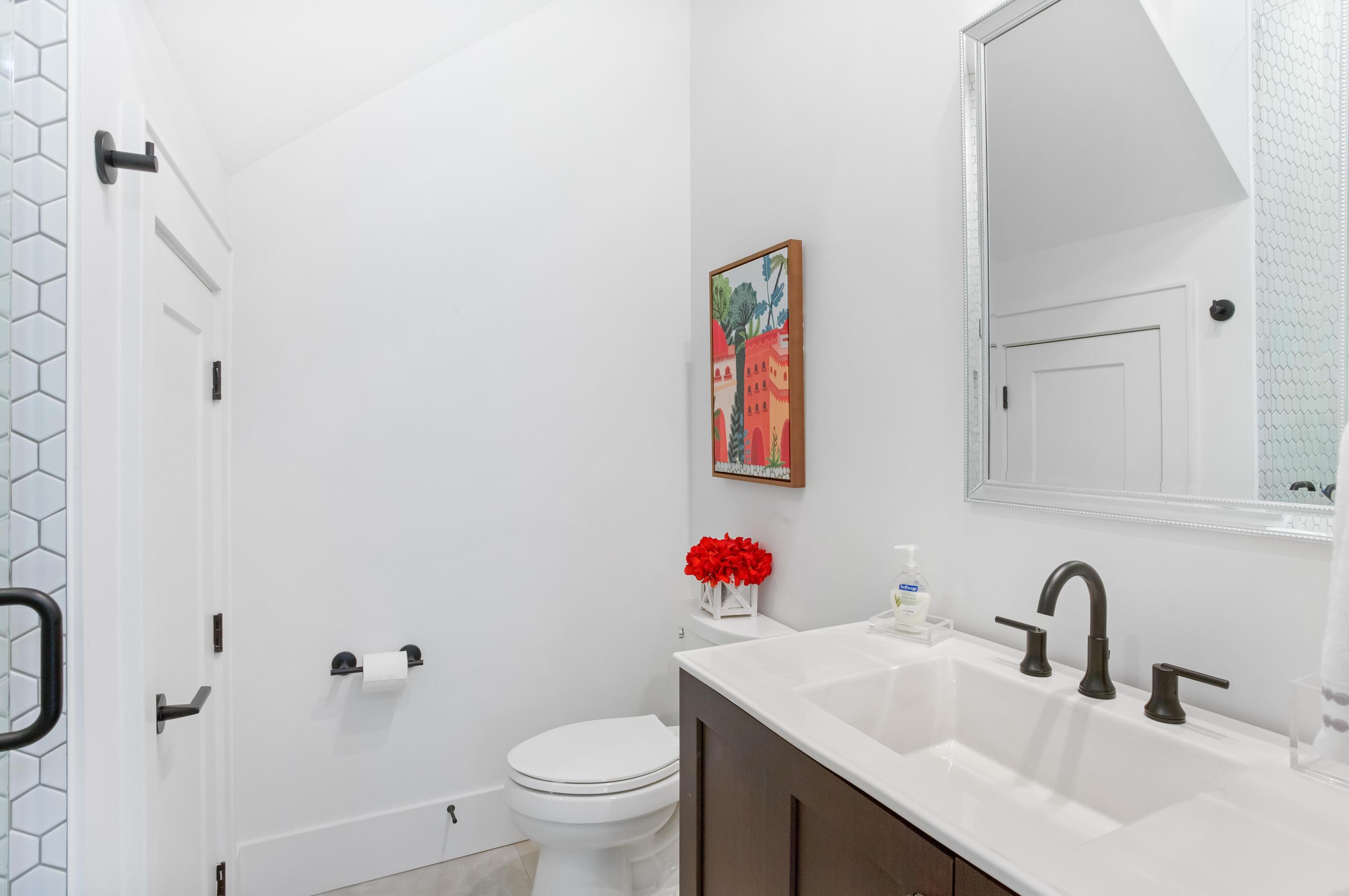 4627 Sunset Pointe Destin, FL 32541 - Photo 33 of 64 a bathroom with a sink and a mirror