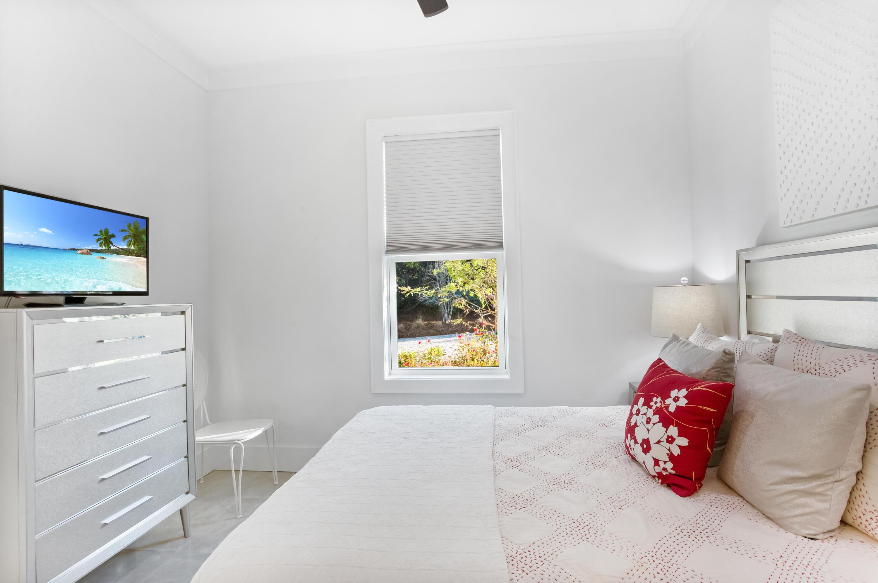 4627 Sunset Pointe Destin, FL 32541 - Photo 35 of 64 a bedroom with a bed and a flat screen tv in a dresser