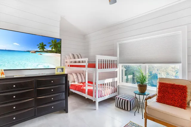 a bed sitting in a bedroom next to a window