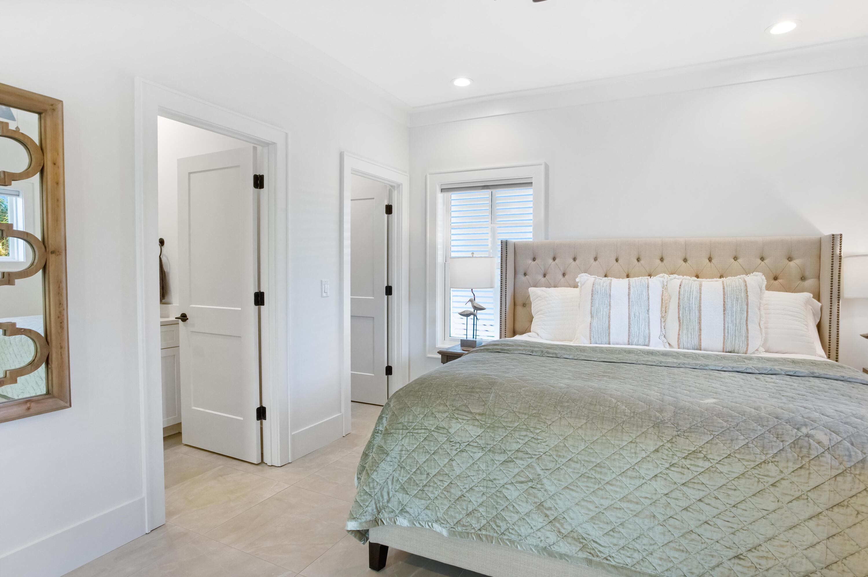 4627 Sunset Pointe Destin, FL 32541 - Photo 40 of 64 a spacious bedroom with a bed and a table