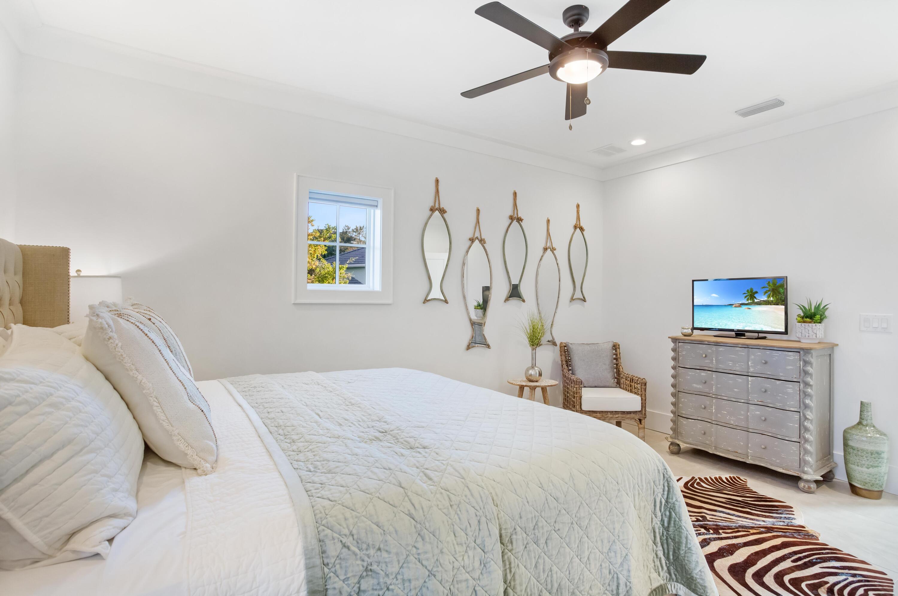 4627 Sunset Pointe Destin, FL 32541 - Photo 41 of 64 a bedroom with a bed and a chandelier