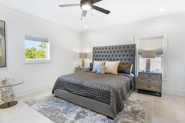 an aerial view of residential houses with outdoor space and trees all around