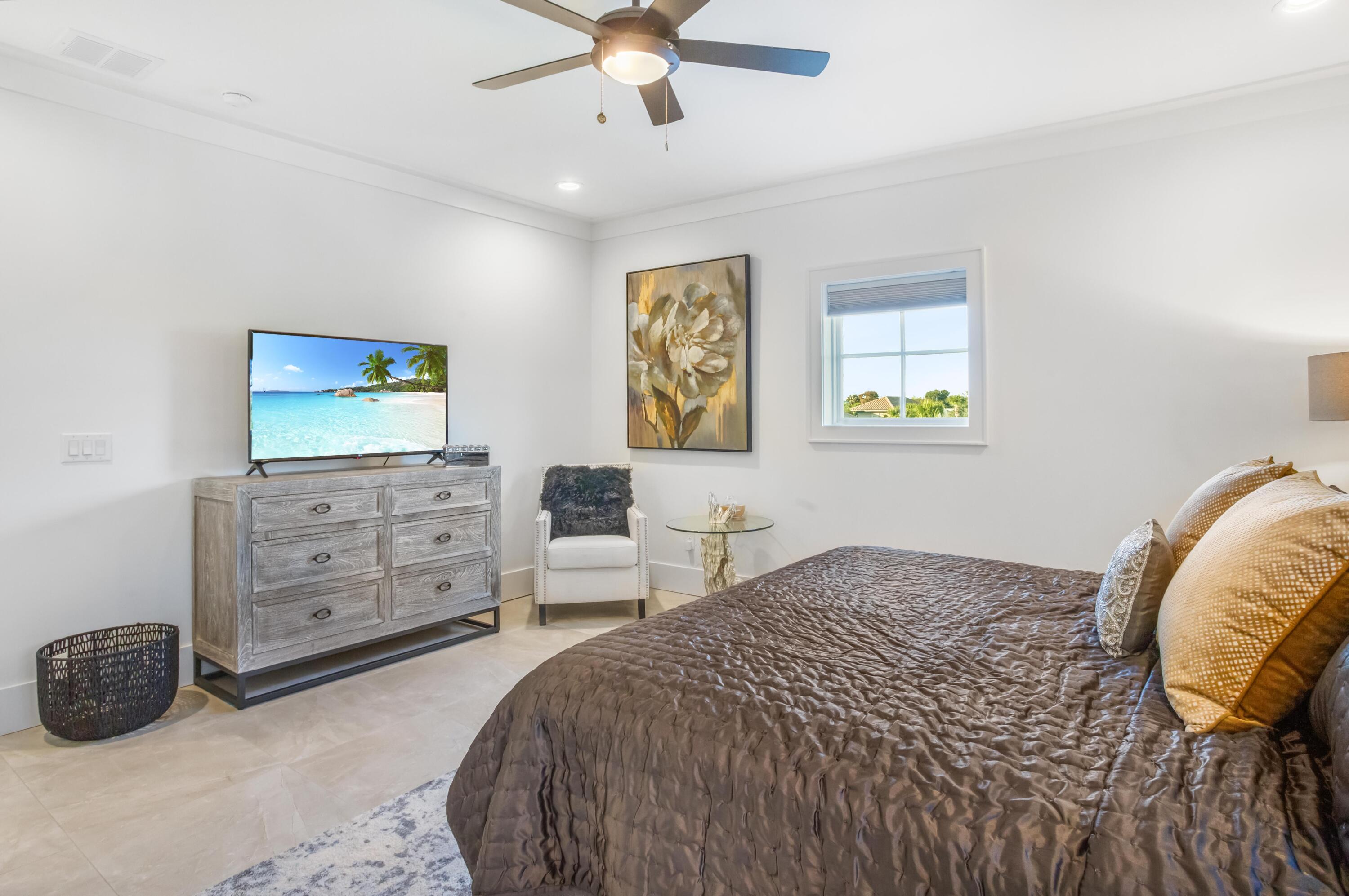 4627 Sunset Pointe Destin, FL 32541 - Photo 50 of 64 a bedroom with a bed and a tv