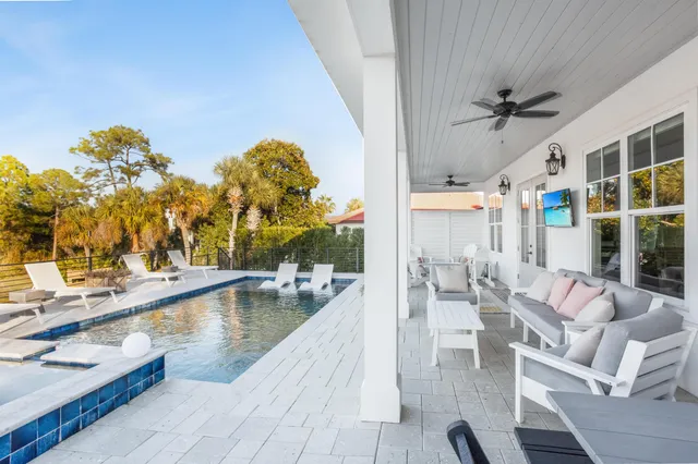 a living room with couches a coffee table and a table with garden view