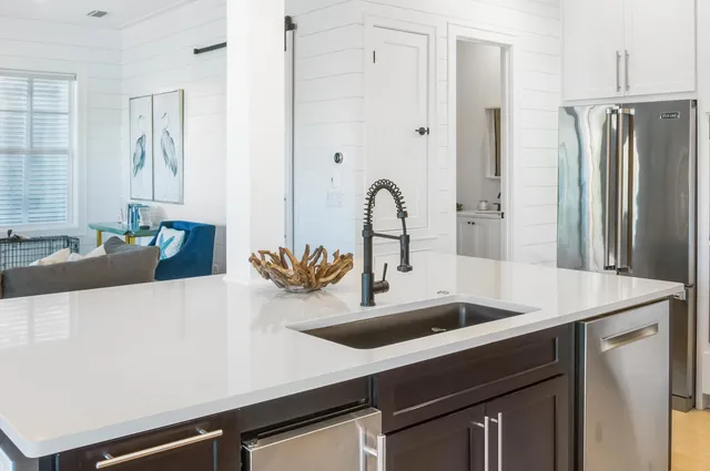 a view of a dining room with furniture a chandelier and wooden floor