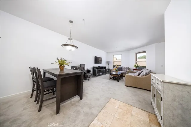 a living room with furniture and a dining table