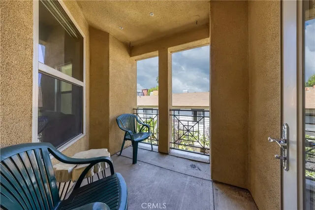 a view of a bedroom with furniture and windows