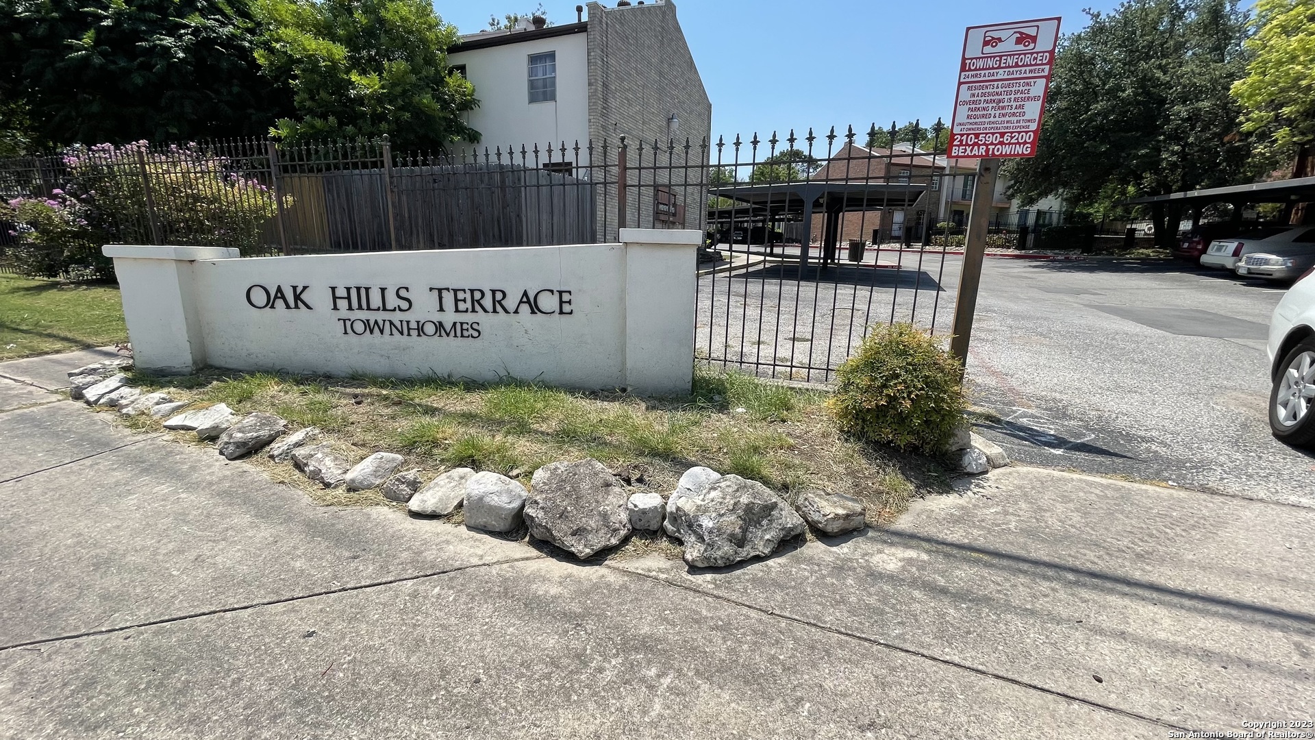 a view of a park with iron fence