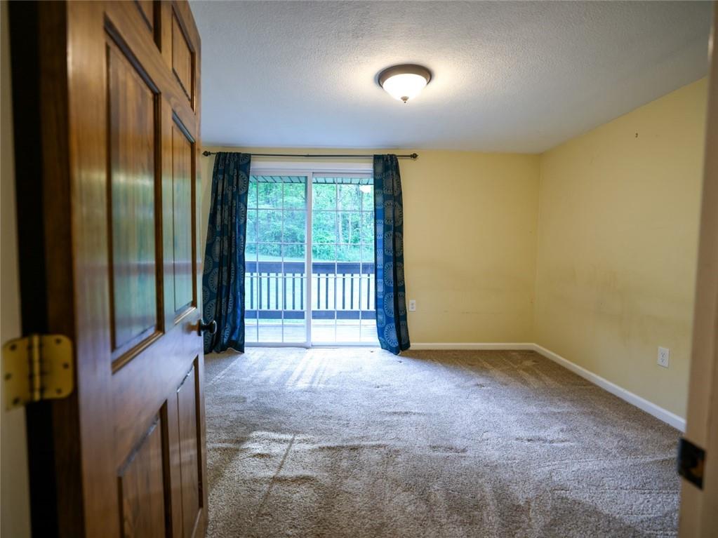 1381 Logan Road Gibsonia, PA 15044 - Photo 8 of 24 a view of an empty room with a sliding door