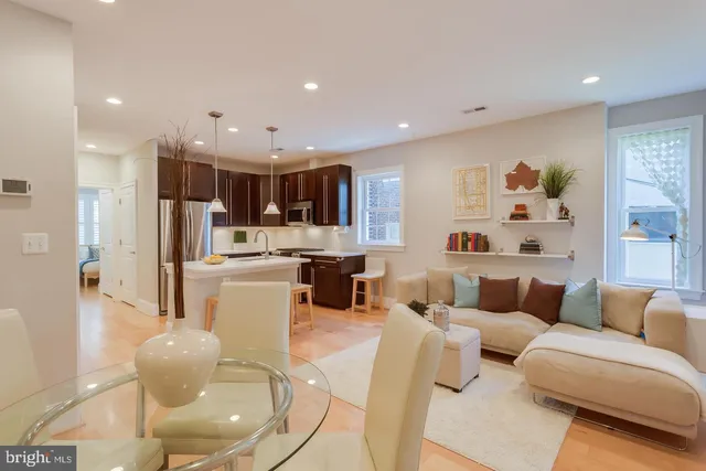 a living room with furniture and kitchen view