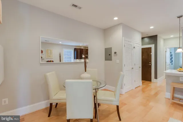 a living room with furniture a mirror and a dining table