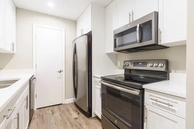 a kitchen with a stove microwave and refrigerator