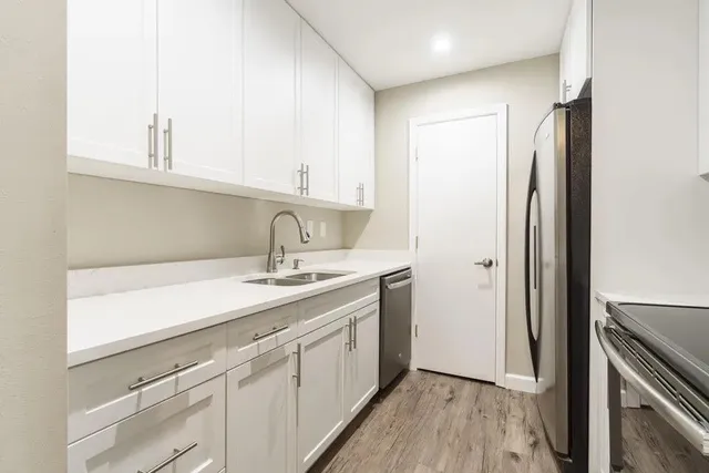 a kitchen with a sink and a refrigerator