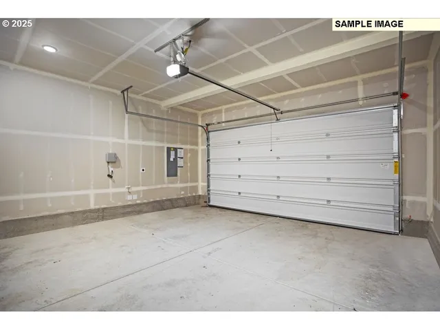 a balcony with table and chairs with potted plants