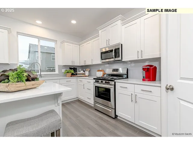 a kitchen with a stove a microwave and cabinets