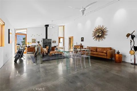a living room with furniture a flat screen tv and a window