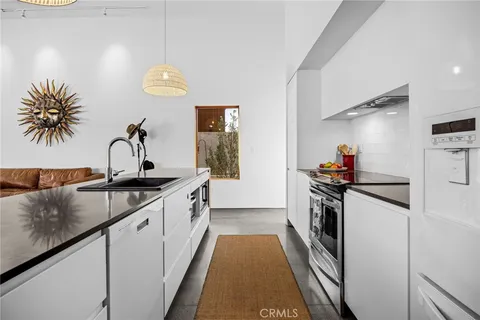a kitchen with stainless steel appliances granite countertop a stove and cabinets