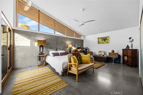 a bathroom with a granite countertop sink toilet and mirror