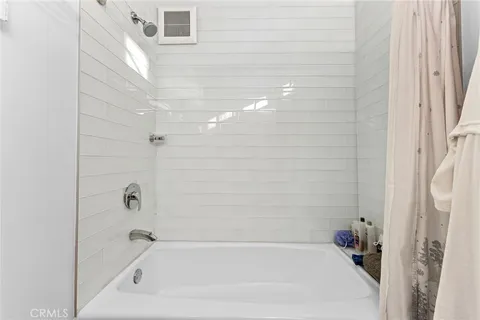 a view of a house with a roof and potted plants