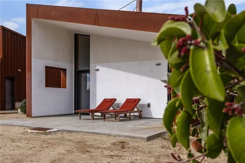 an aerial view of a house with a mountain