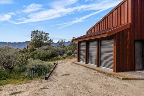 a view of a chair and table in the backyard