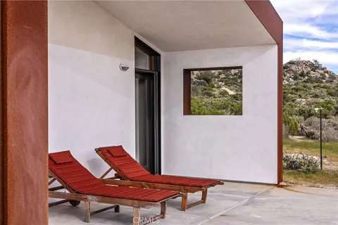 a backyard of a house with table and chairs