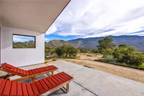 a view of a backyard with furniture and a grill
