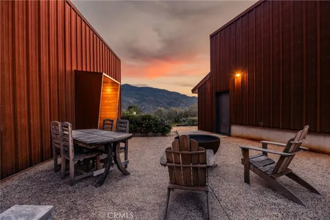 a backyard of a house with table and chairs